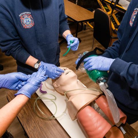 A group of students working with medical dummy